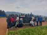 Students stand behind UGHE sign